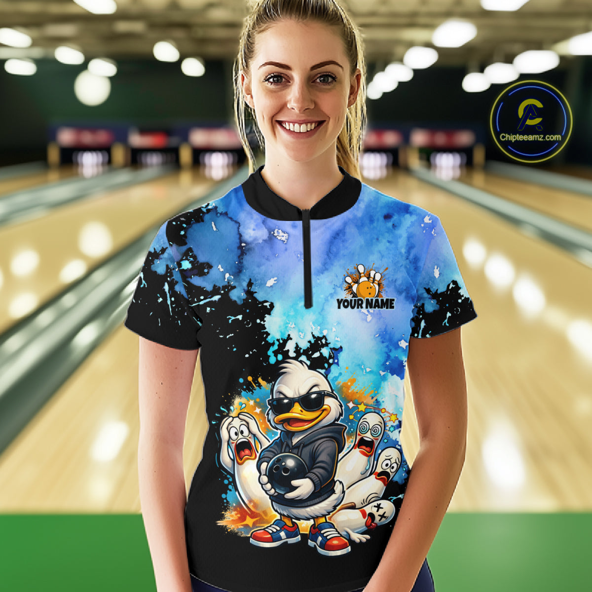 Person wearing a colorful bowling shirt with cartoon characters in a bowling alley.