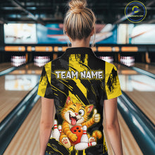 Load image into Gallery viewer, Female model wearing a custom black yellow cat bowling polo shirt back view displaying the personalized team name above a playful cartoon cat graphic at the bowling alley