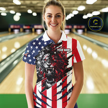 Load image into Gallery viewer, Woman wearing a custom polo shirt with a lion design and American flag pattern in a bowling alley.