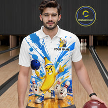 Load image into Gallery viewer, Man wearing a white polo shirt with a colorful design of a banana character and bowling pins in a bowling alley.