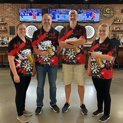 Four people standing together in a bar or lounge setting, wearing matching black short-sleeve polo shirts with a red, white, and gray graphic design featuring beer glasses and a dartboard motif. The background shows brick walls, multiple sports TVs, dartboards, and bar fixtures.