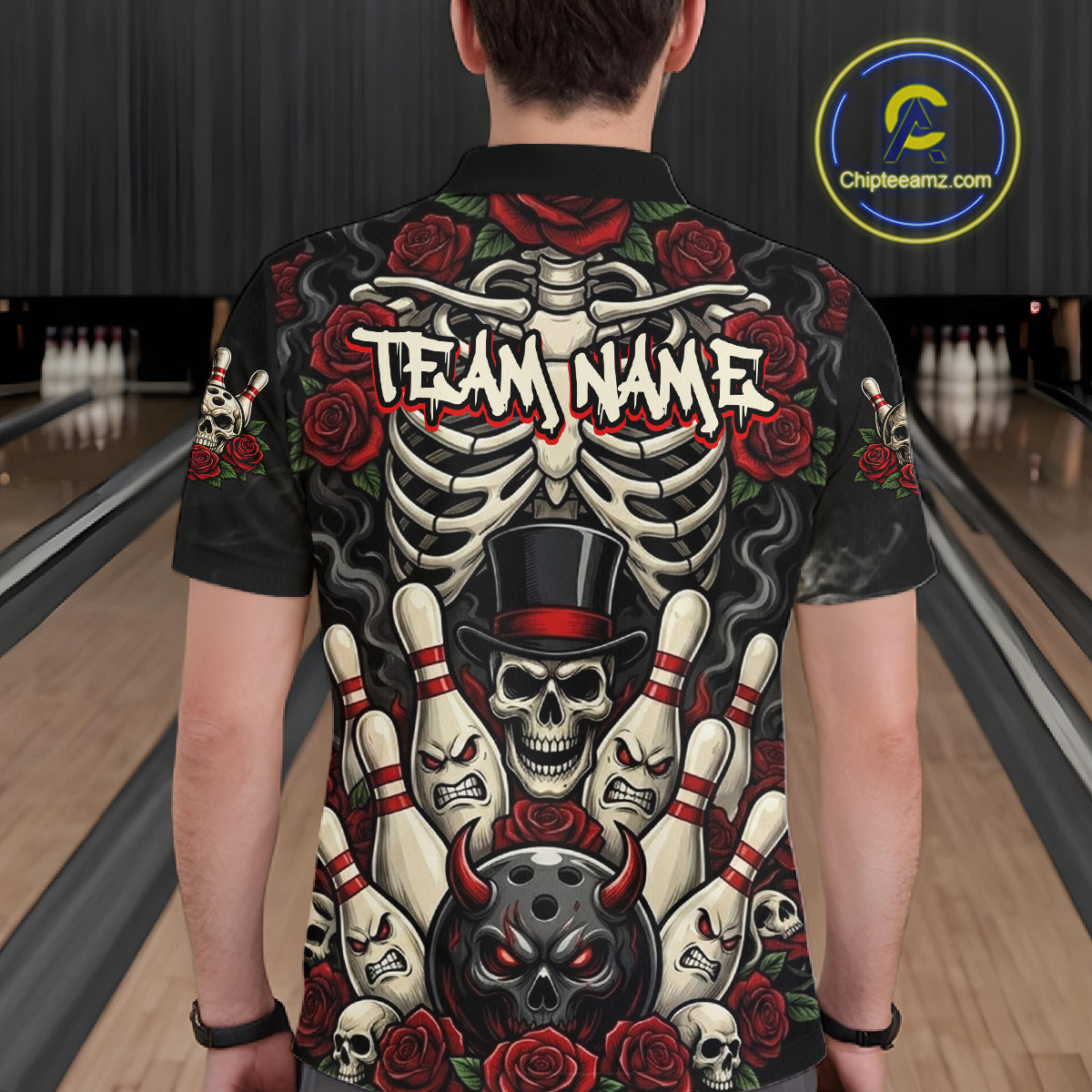 A person viewed from behind wearing a black short-sleeve polo shirt with a large bowling-themed graphic print featuring a skeleton, bowling pins, skulls, red roses, and the text 'TEAM NAME'. The background shows bowling lanes.