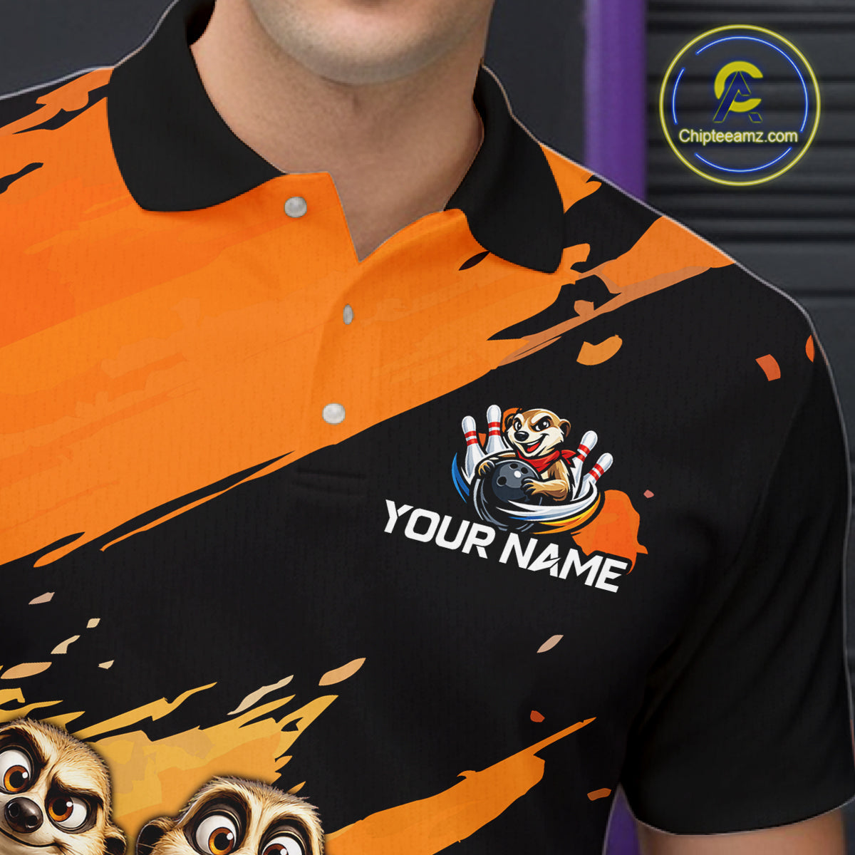 A close-up of a person wearing a short-sleeve polo shirt with a bold orange and black graphic design, featuring cartoon animal faces and a custom name patch that reads 'YOUR NAME'.