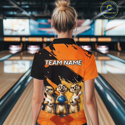 A woman viewed from behind wearing a custom bowling-themed short-sleeve polo shirt with cartoon meerkats and 'TEAM NAME' printed on the back, set against a blurred bowling alley background.