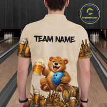 Load image into Gallery viewer, Person wearing a shirt with a bear holding a bowling ball and beer design, standing in a bowling alley.
