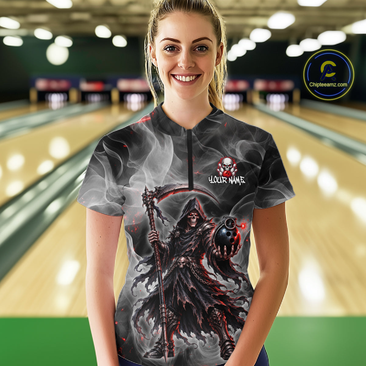 A woman stands in a bowling alley wearing a short-sleeve half-zip shirt with a grim reaper graphic and the text 'YOUR NAME'. The background shows blurred bowling lanes