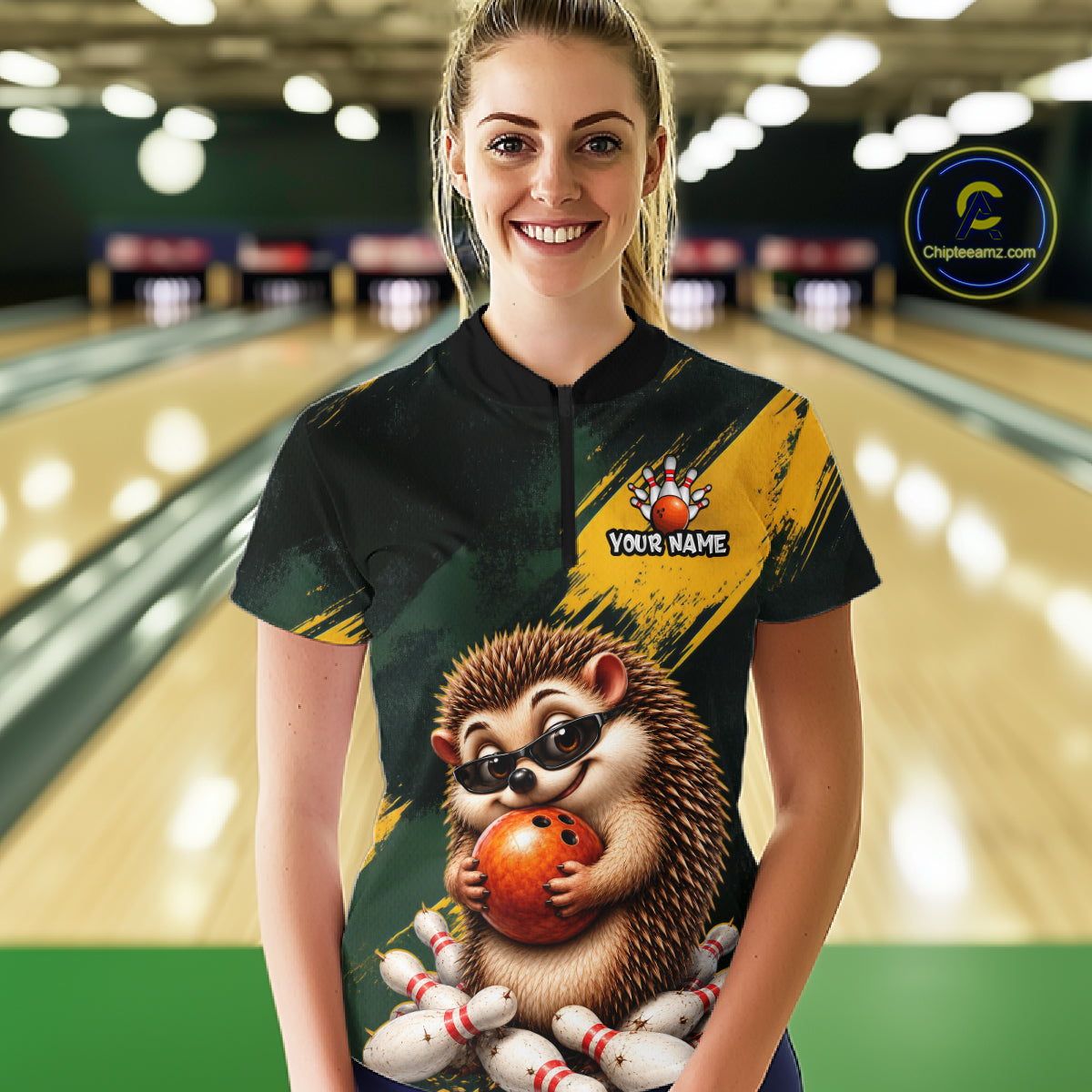 A woman stands in a bowling alley wearing a custom short-sleeve bowling jersey. The jersey features a black and yellow background with a cartoon hedgehog holding an orange bowling ball on the front, along with a 'YOUR NAME' customization placeholder.