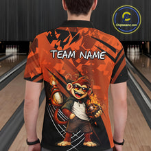 Load image into Gallery viewer, A man viewed from behind wearing a short-sleeve bowling-themed polo shirt with a large cartoon monkey graphic and the text 'TEAM NAME' on the back. The shirt has an orange and black geometric pattern, and the background shows blurred bowling lanes.