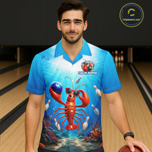 Load image into Gallery viewer, Man wearing a blue bowling shirt with a lobster design in a bowling alley.