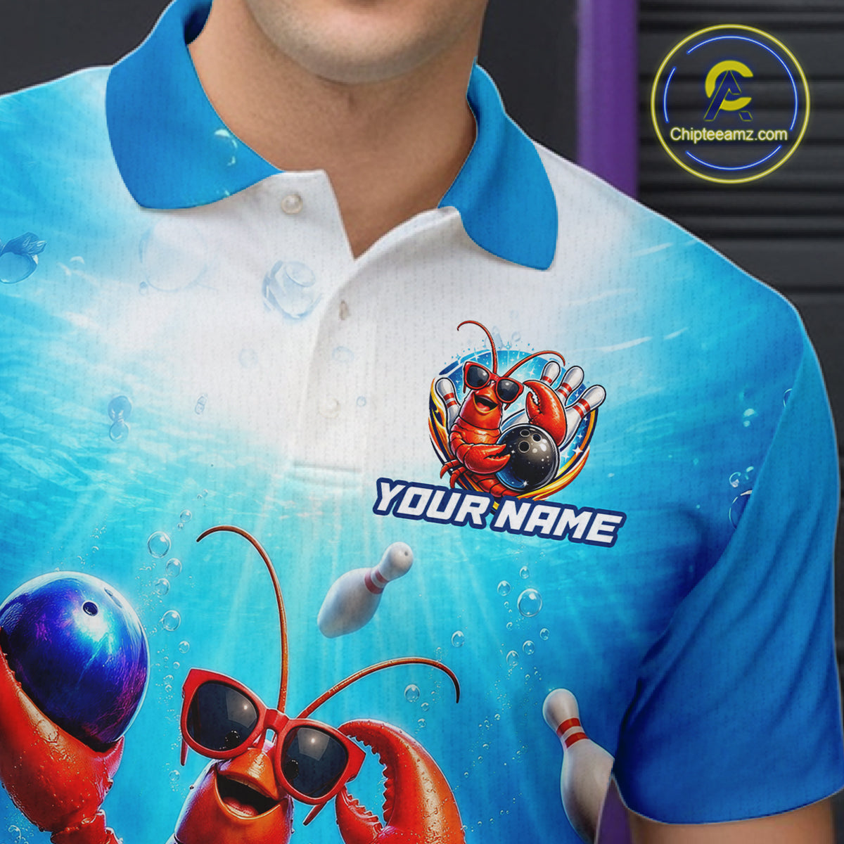 Person wearing a blue and white polo shirt with a cartoon lobster design and 'Your Name' text.