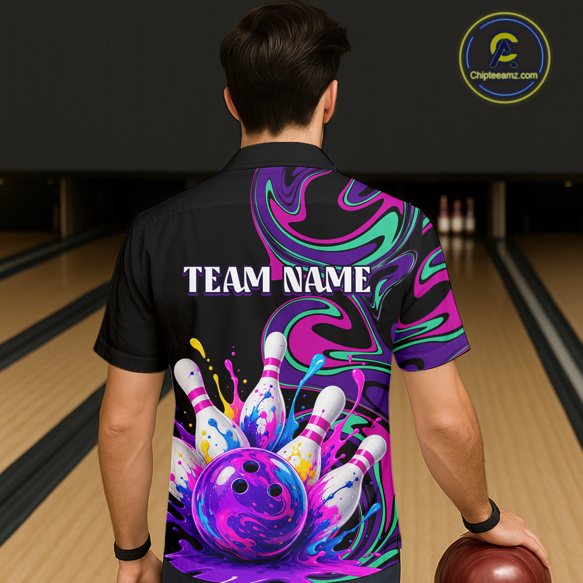 Person wearing a colorful bowling shirt with 'TEAM NAME' text in a bowling alley.