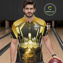 Load image into Gallery viewer, Male model wearing a custom black gold bowling polo shirt front view featuring a glowing bowling ball, illuminated bowling pins and gold geometric light beam pattern at the bowling alley