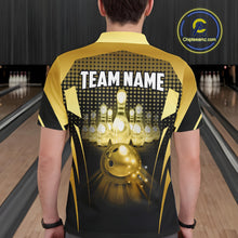 Load image into Gallery viewer, Male model wearing a custom black gold bowling polo shirt back view displaying the personalized team name above a glowing bowling ball and illuminated bowling pins graphic at the bowling alley