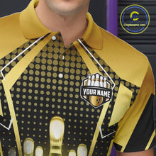 Load image into Gallery viewer, Close-up front view of a custom black gold bowling polo shirt showing the personalized player name, glowing bowling ball graphic and gold geometric light beam design