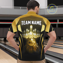 Load image into Gallery viewer, Male model wearing a custom black gold bowling quarter-zip shirt back view displaying the personalized team name above a glowing bowling ball and illuminated bowling pins graphic at the bowling alley