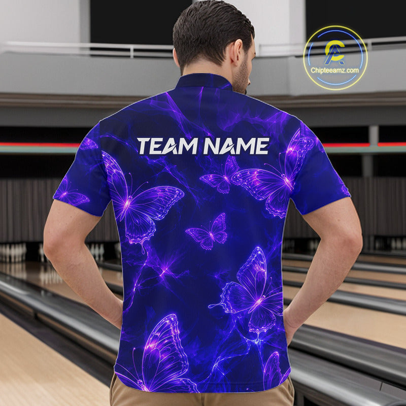 A man viewed from behind wearing a short-sleeve bowling shirt with a purple and blue neon butterfly pattern and 'TEAM NAME' printed across the back. Bowling lanes are visible in the background