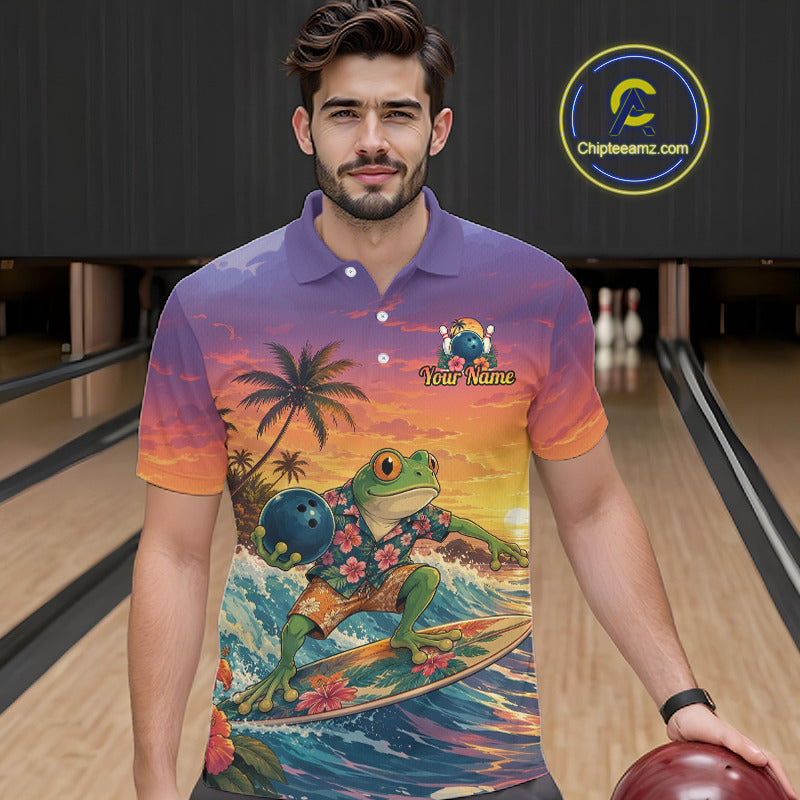 A man in a bowling alley wearing a colorful short-sleeve polo shirt with a tropical frog surfing graphic. The shirt features a purple-to-orange gradient background with a green frog on a surfboard, palm trees, and a bowling ball graphic.