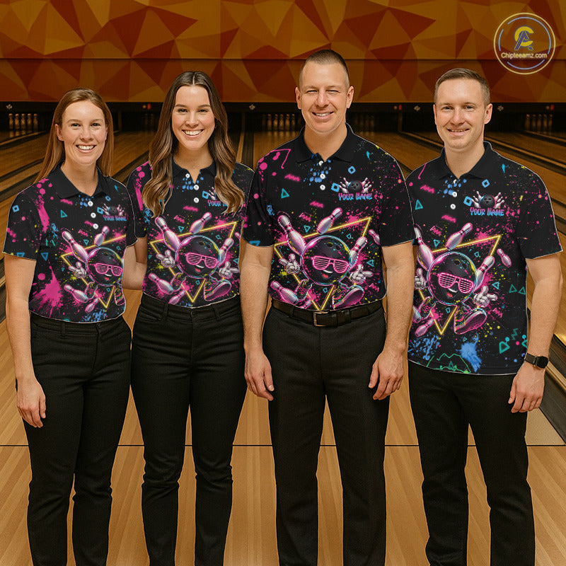 Four people standing in a bowling alley wearing matching black short-sleeve polo shirts with a colorful neon bowling-themed graphic print, paired with black pants.