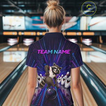 Load image into Gallery viewer, Person wearing a bowling-themed shirt with a raccoon design in a bowling alley.