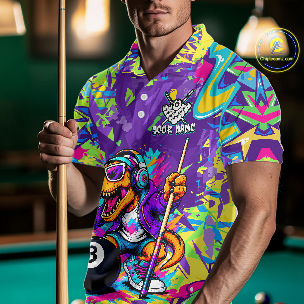 Person wearing a colorful polo shirt with a graphic design, holding a pool cue in a billiards setting.
