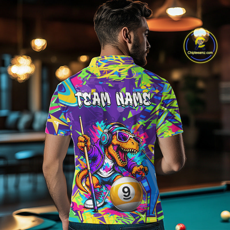 Person wearing a graffiti dinosaur shirt with a dinosaur design and 'Team Name' text, standing in a pool hall.