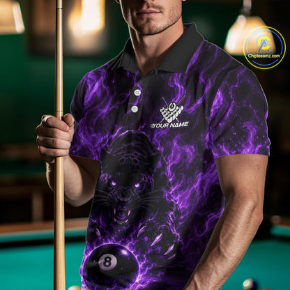 A man wearing a black and purple short-sleeve polo shirt with a glowing purple panther and billiard ball graphic, holding a pool cue in a dimly lit billiards room. 