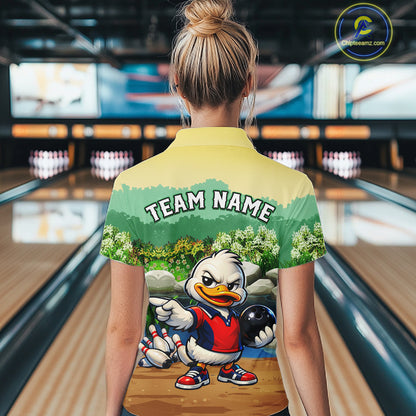 Person wearing a bowling-themed shirt with a cartoon duck character in a bowling alley.