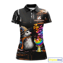 Load image into Gallery viewer, A women's short-sleeve polo shirt with a black base and a detailed graphic print featuring a witch opossum wearing a hat and scarf next to a colorful bowling ball, with 'YOUR NAME' placeholder text on the chest.