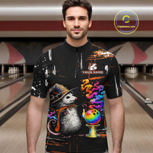 Load image into Gallery viewer, A man wearing a black short-sleeve quarter-zip cycling jersey with a colorful graphic print of a witch opossum and bowling balls, set against a blurred bowling alley background. 