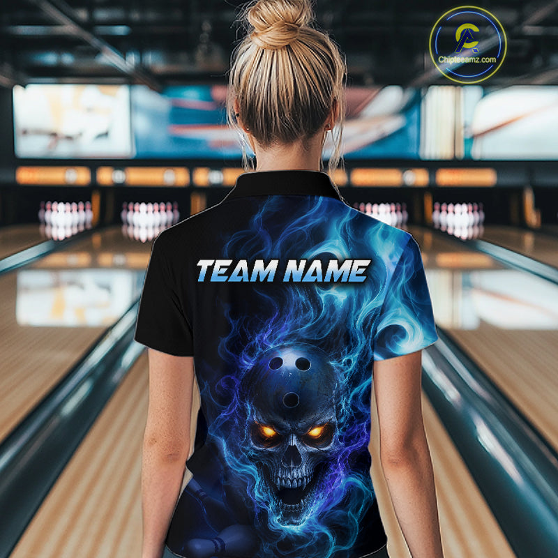 Woman wearing a black bowling polo shirt featuring a flaming skull with glowing orange eyes, blue smoke effects, and custom “TEAM NAME” text.