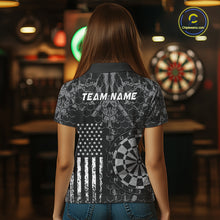 Load image into Gallery viewer, Women wearing darts polo shirt featuring dartboard graphics blended with a american flag flag pattern on a black gray background.
