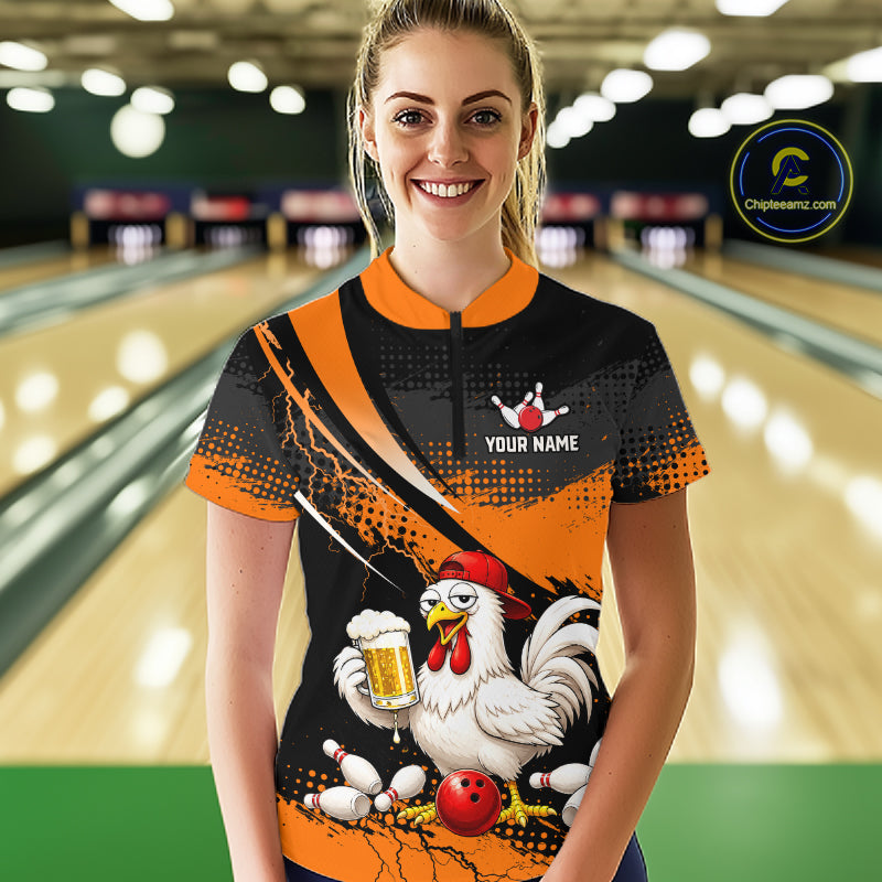 Woman wearing a orange and black bowling quarter zip featuring a chicken holding a beer mug, red bowling ball, scattered pins, and custom your name text.