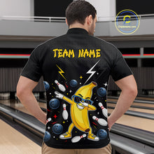 Load image into Gallery viewer, Man wearing a black bowling polo with a banana character and 'Team Name' text in a bowling alley.