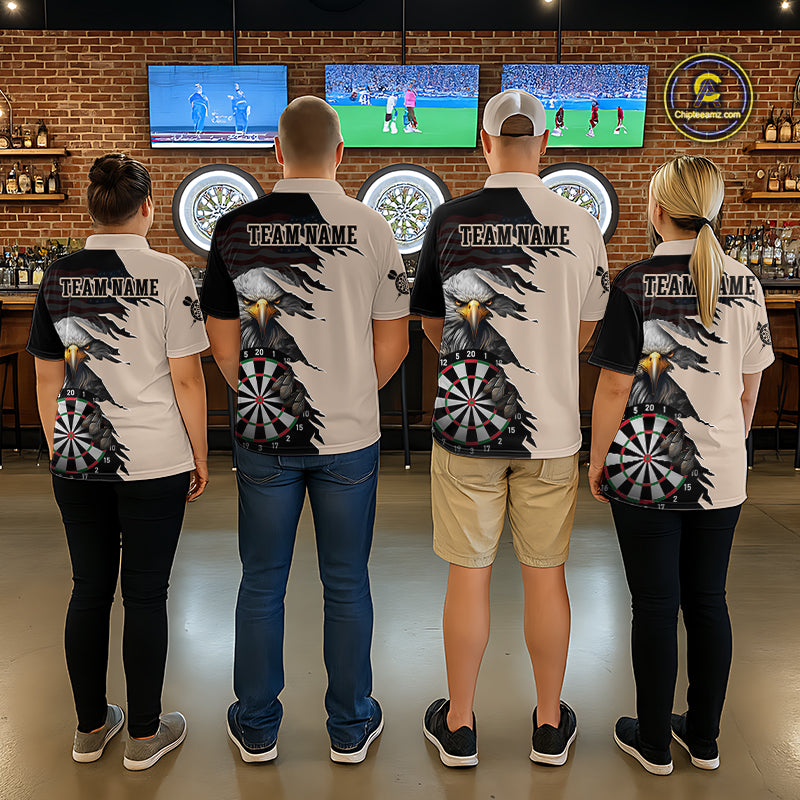 Four people wearing beige and black darts polo featuring a bald eagle, torn-flag graphics, dartboard designs, and custom team text.
