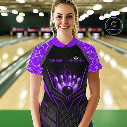 Person wearing a personalized bowling shirt with a purple and black design in a bowling alley.