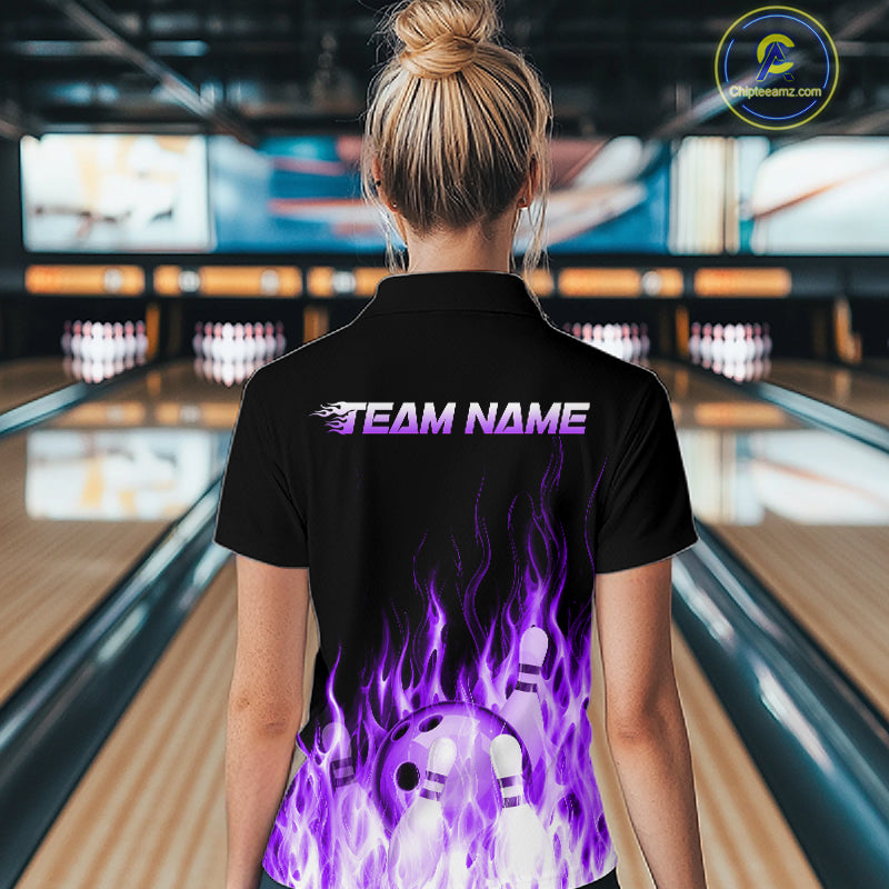 Person wearing a black bowling shirt with purple designs and 'Team Name' text in a bowling alley.