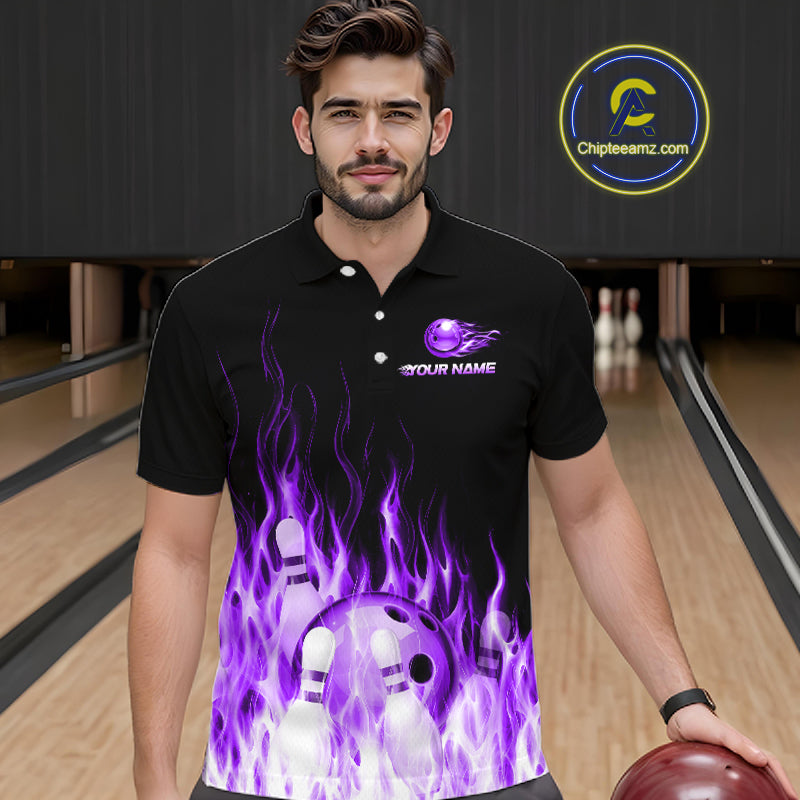 Man wearing a black bowling shirt with a purple flame design in a bowling alley.