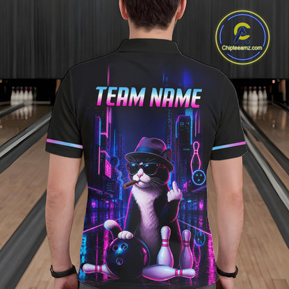 A man wearing a black short-sleeve bowling-themed quarter-zip shirt with a colorful neon cat graphic, standing in a bowling alley. The shirt features a black and white cat wearing a hat and sunglasses, holding bowling pins and a bowling ball, with the text 'TEAM NAME' and bowling pins above.