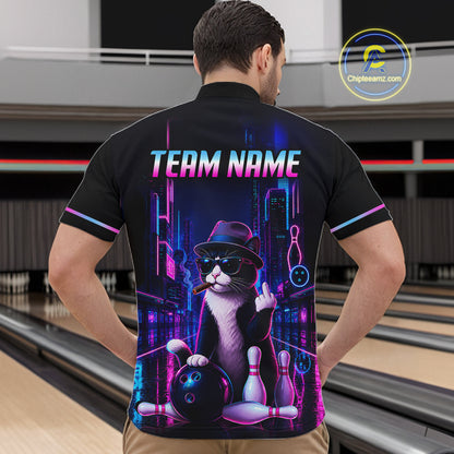 A man wearing a black short-sleeve bowling-themed quarter-zip shirt with a colorful neon cat graphic, standing in a bowling alley. The shirt features a black and white cat wearing a hat and sunglasses, holding bowling pins and a bowling ball, with the text 'TEAM NAME' and bowling pins above.