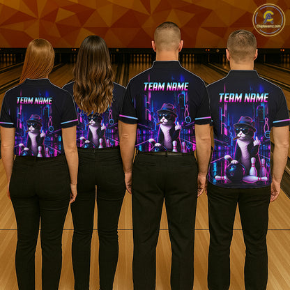 Four people standing from the back in a bowling alley, wearing matching dark navy polo shirts with a large graphic print of a cat playing bowling and the text 'TEAM NAME' on the back.
