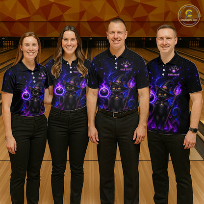 Four people standing in a bowling alley wearing matching black short-sleeve polo shirts with a purple and black cosmic cat graphic on the front. 