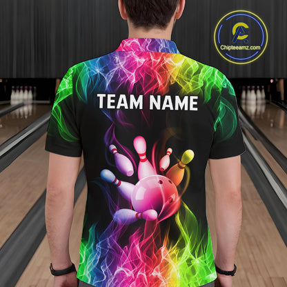 A man viewed from behind wearing a black short-sleeve bowling shirt with a vibrant rainbow smoke graphic and a bowling ball striking pins design. The shirt features the customizable text 'TEAM NAME' on the back.