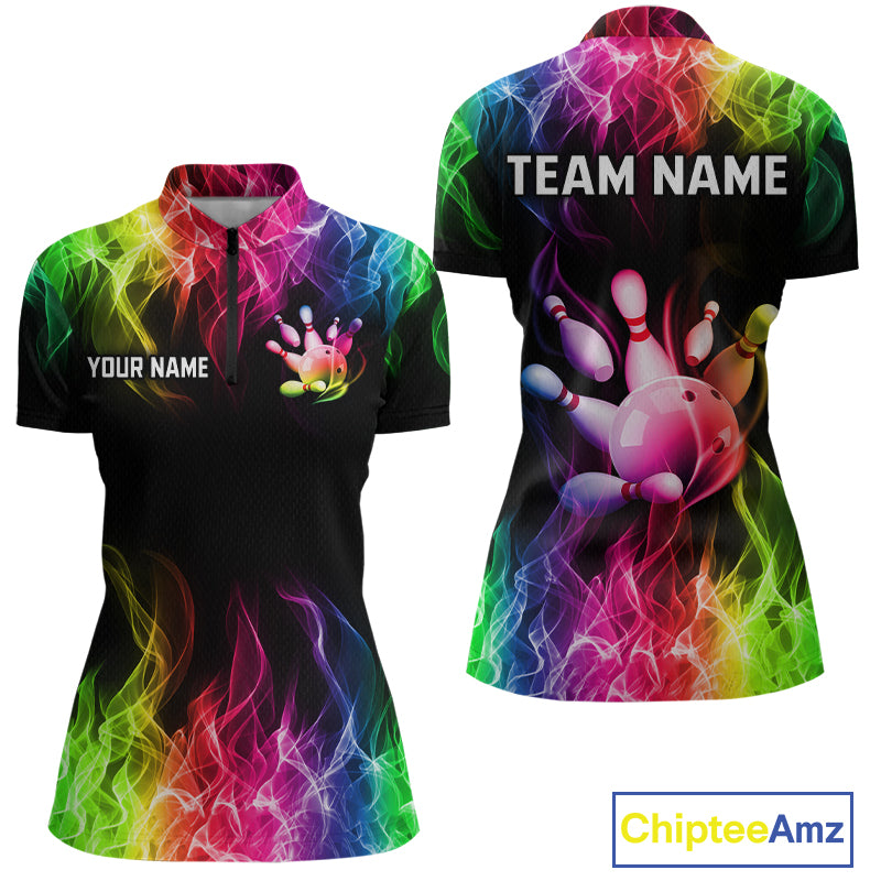 Front and back views of a women's short-sleeve polo shirt with a black base and vibrant neon rainbow flame pattern. The front features a mock neck, a half-zip, and customizable text placeholders 'YOUR NAME' and 'TEAM NAME' with a bowling pin graphic.