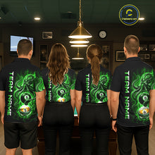 Load image into Gallery viewer, Four people wearing black shirts with green and white designs, standing in a room with a pool table.