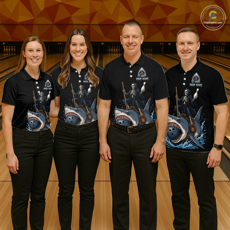 Four people standing in a bowling alley wearing matching black polo shirts with a shark and fishing-themed graphic print. The shirts also feature a small white logo that reads 'YOUR NAME'
