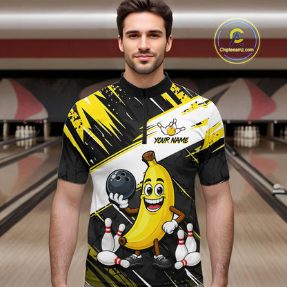 Man wearing a bowling-themed shirt with a banana character in a bowling alley.