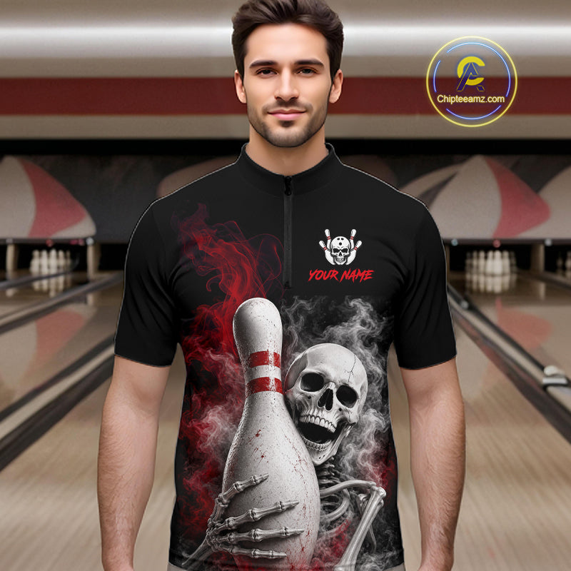 A man wearing a black short-sleeve zip-up bowling shirt with a large graphic of a skeleton holding a bowling pin, red smoke details, and 'YOUR NAME' text on the chest, set against a blurred bowling alley background.