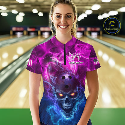 A woman wearing a short-sleeve bowling jersey with a purple and blue skull graphic, standing in a bowling alley. The jersey features a black zipper at the collar, a custom logo on the chest, and American flag graphics on the sleeves.
