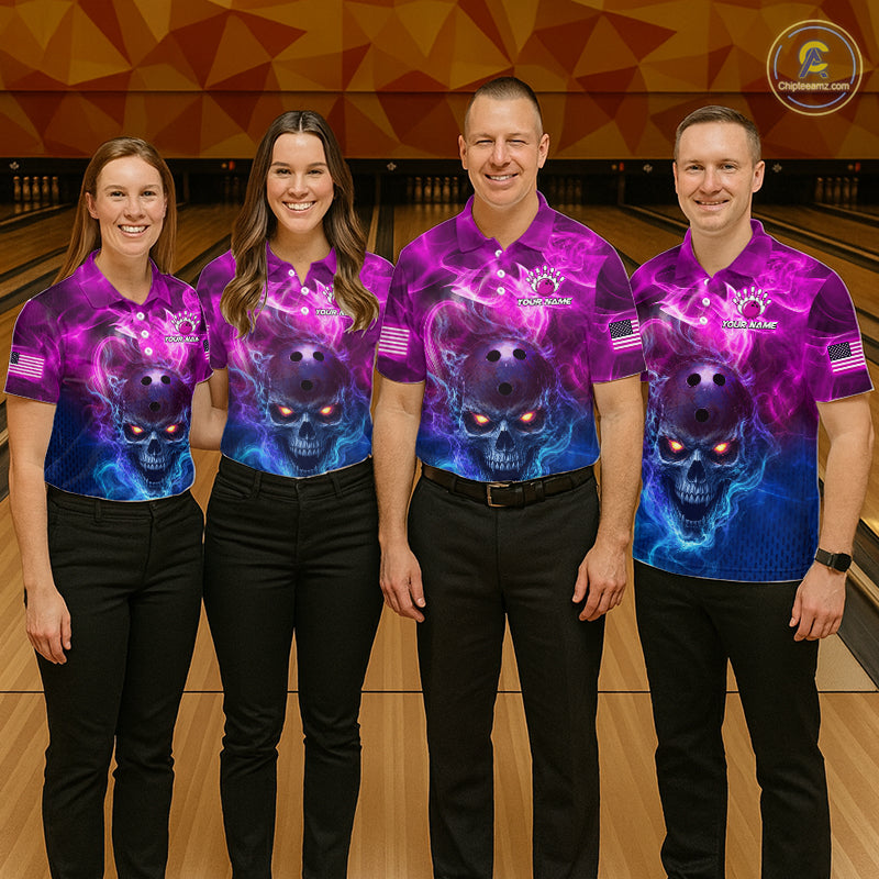 Four people standing in a bowling alley wearing matching purple and blue skull-print bowling shirts and black pants. The shirts feature a glowing skull graphic with pink, purple, and blue nebula-style artwork, and the bowling pin logo on the chest.
