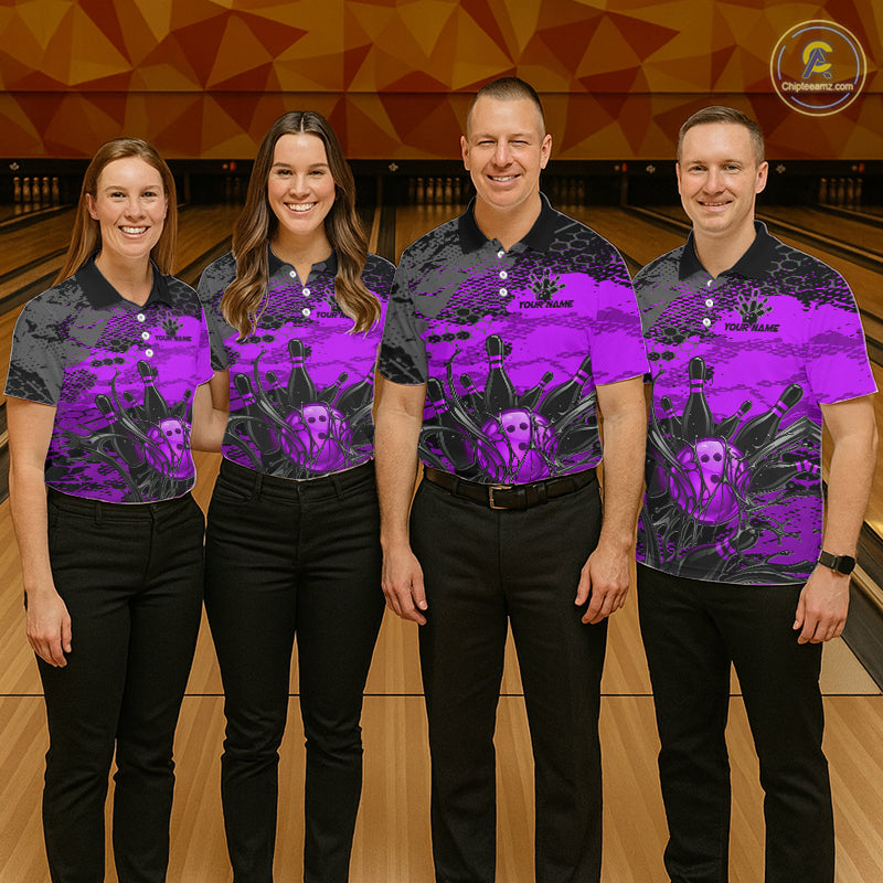 Four people wearing bowling shirts with a purple and black design on a bowling alley.